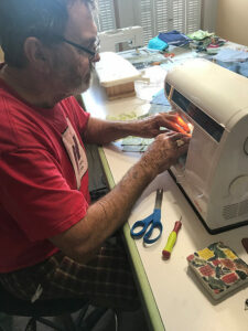 Photo of a man using a sewing machine