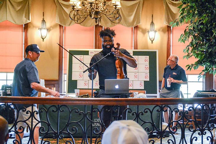 Photo of a violinist setting up to play