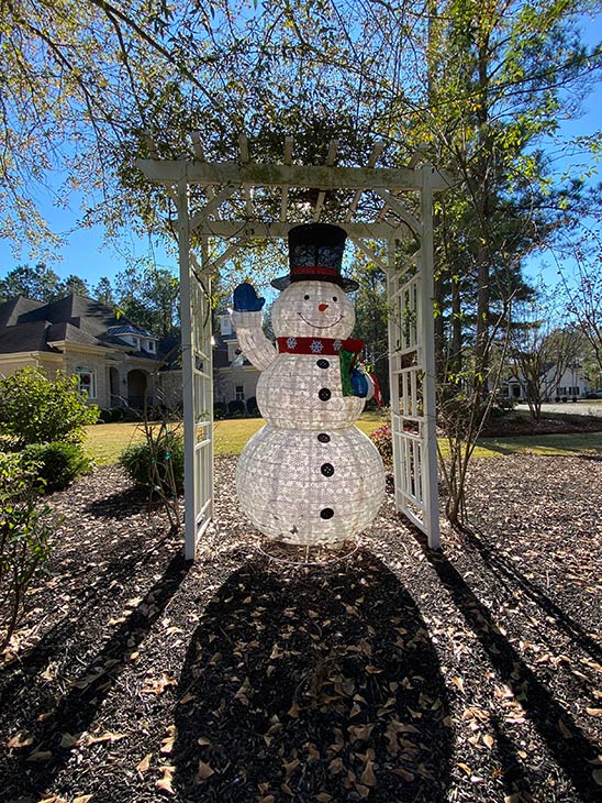 Photo of snowman decoration in front yard of home