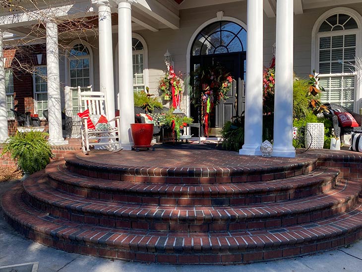 Photo of Christmas decorations on front porch of home