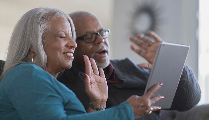 Photo of couple looking at a tablet