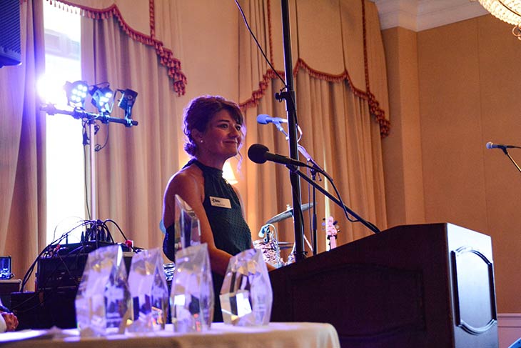 Photo of a woman standing at a podium at the Hope For The Warriors 2021